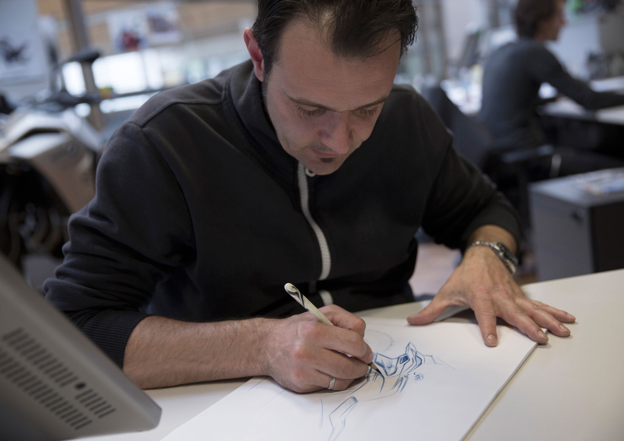 A designer sketches the BMW 310 GS.